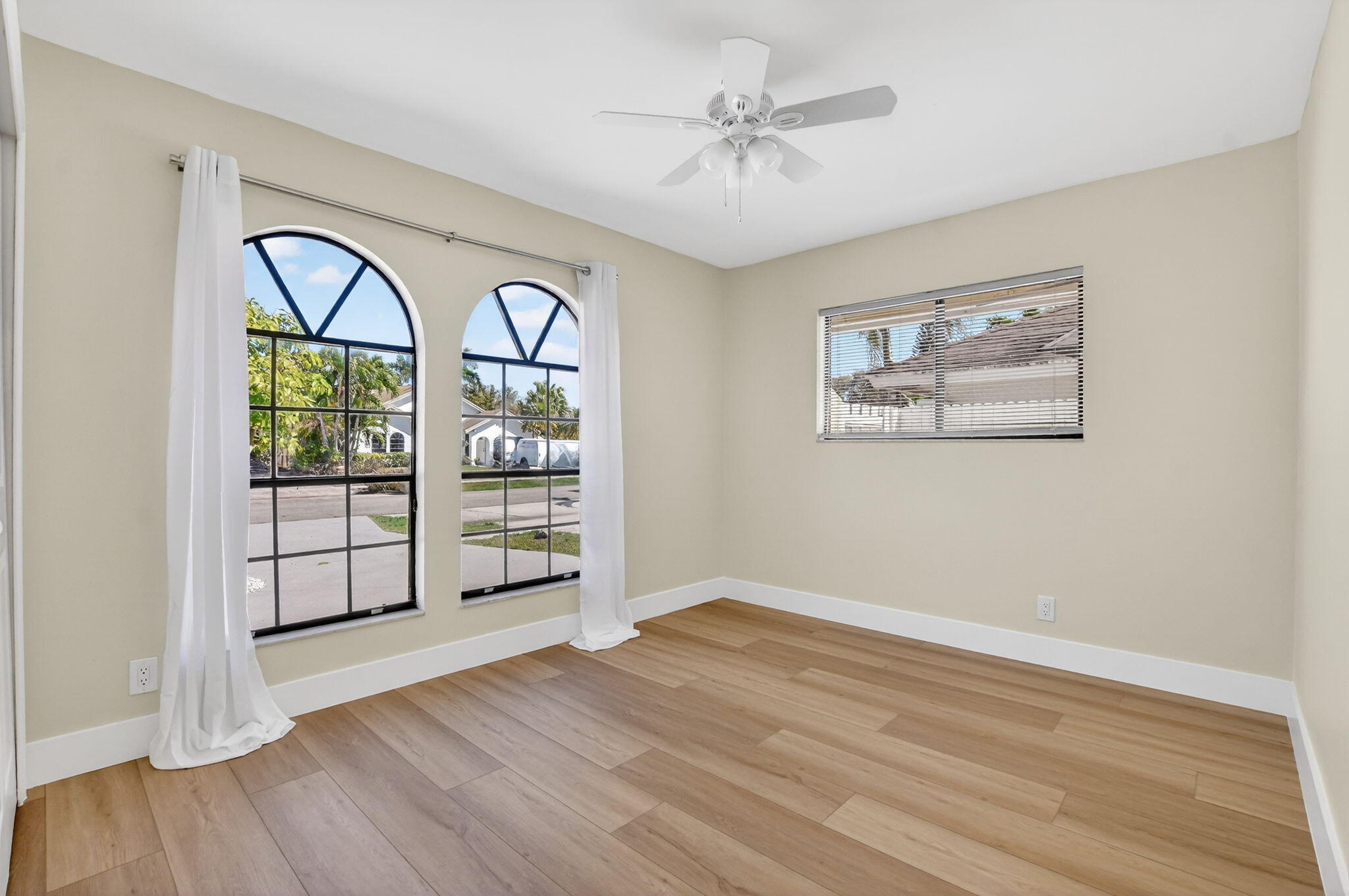 22732 Pickerel Circle Boca Raton, FL 33428 - Photo 26 of 38 a view of an empty room with wooden floor and a window