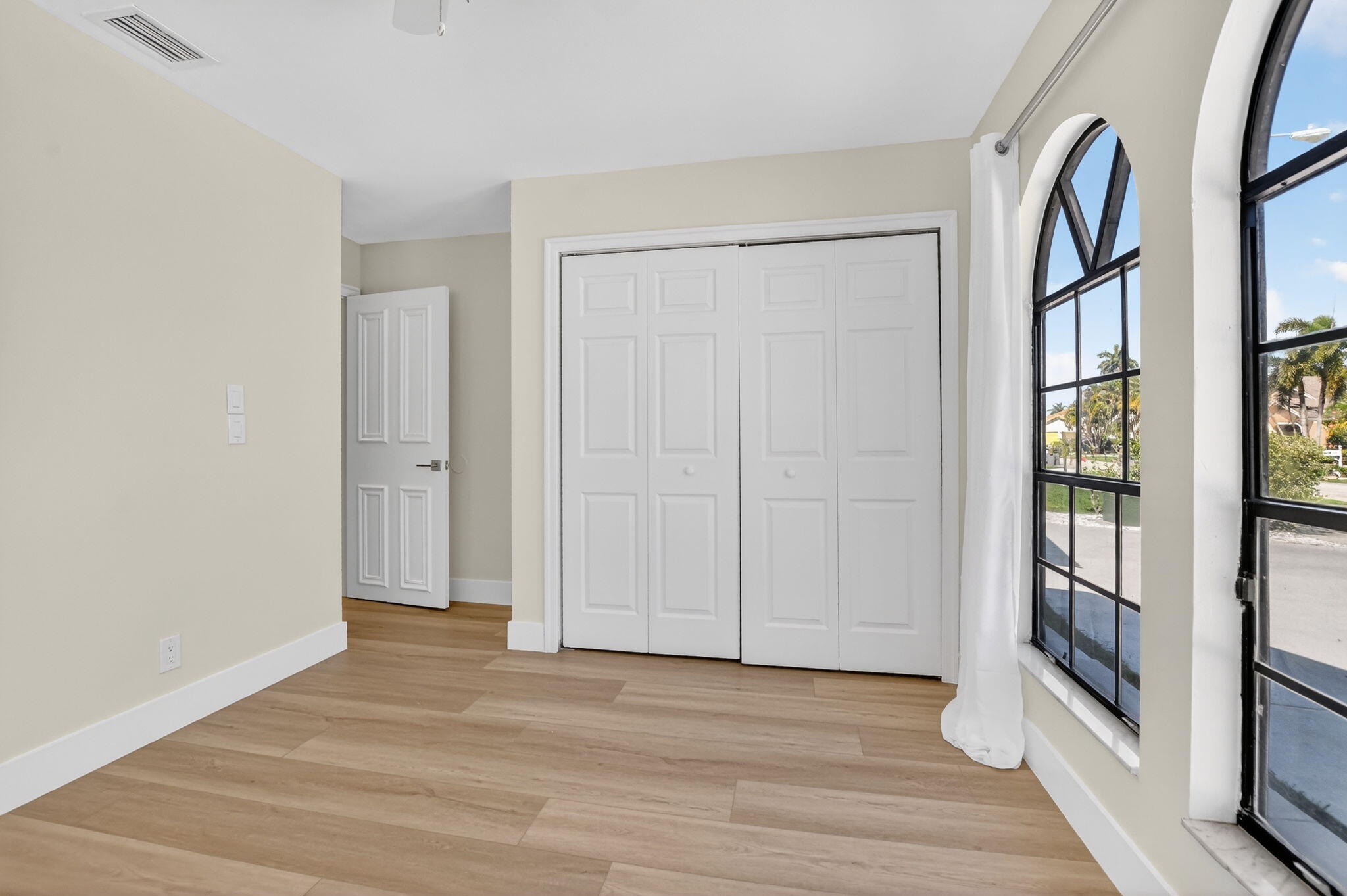 22732 Pickerel Circle Boca Raton, FL 33428 - Photo 27 of 38 an empty room with wooden floor and windows