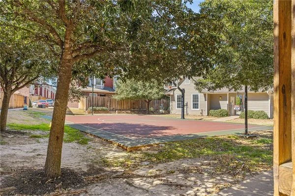 a front view of a house with a yard and tree s