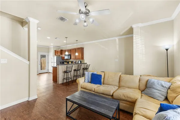 a living room with furniture and kitchen view