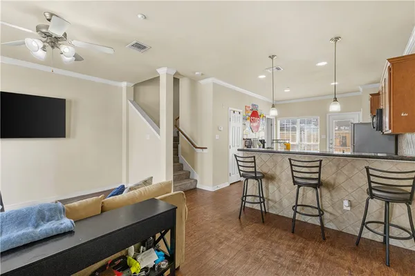 a kitchen with a table chairs refrigerator and microwave