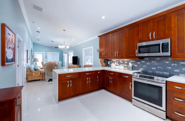 a kitchen with stainless steel appliances granite countertop wooden cabinets a stove top oven a sink and dishwasher