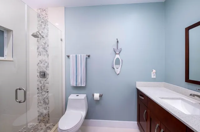 a bathroom with a sink a toilet and shower curtain
