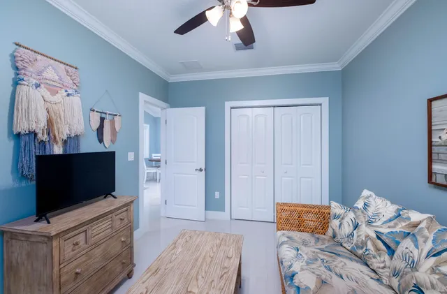 a bedroom with furniture and a flat screen tv