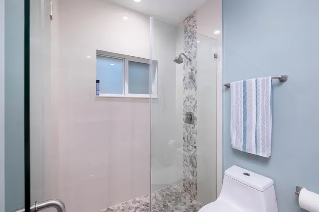 a bathroom with a shower and a toilet