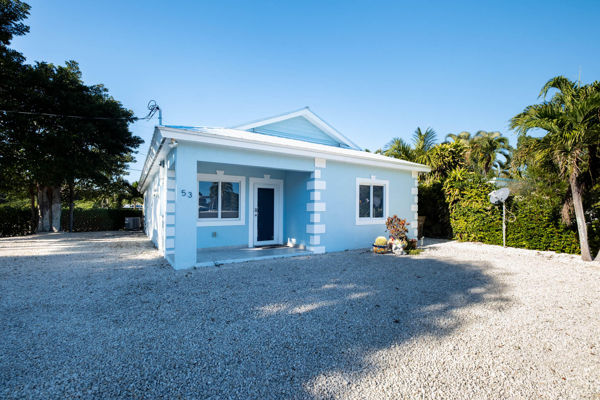 53 Jenny Lane Key Largo, FL 33037 - Photo 2 of 26 a view of a house with backyard and trees