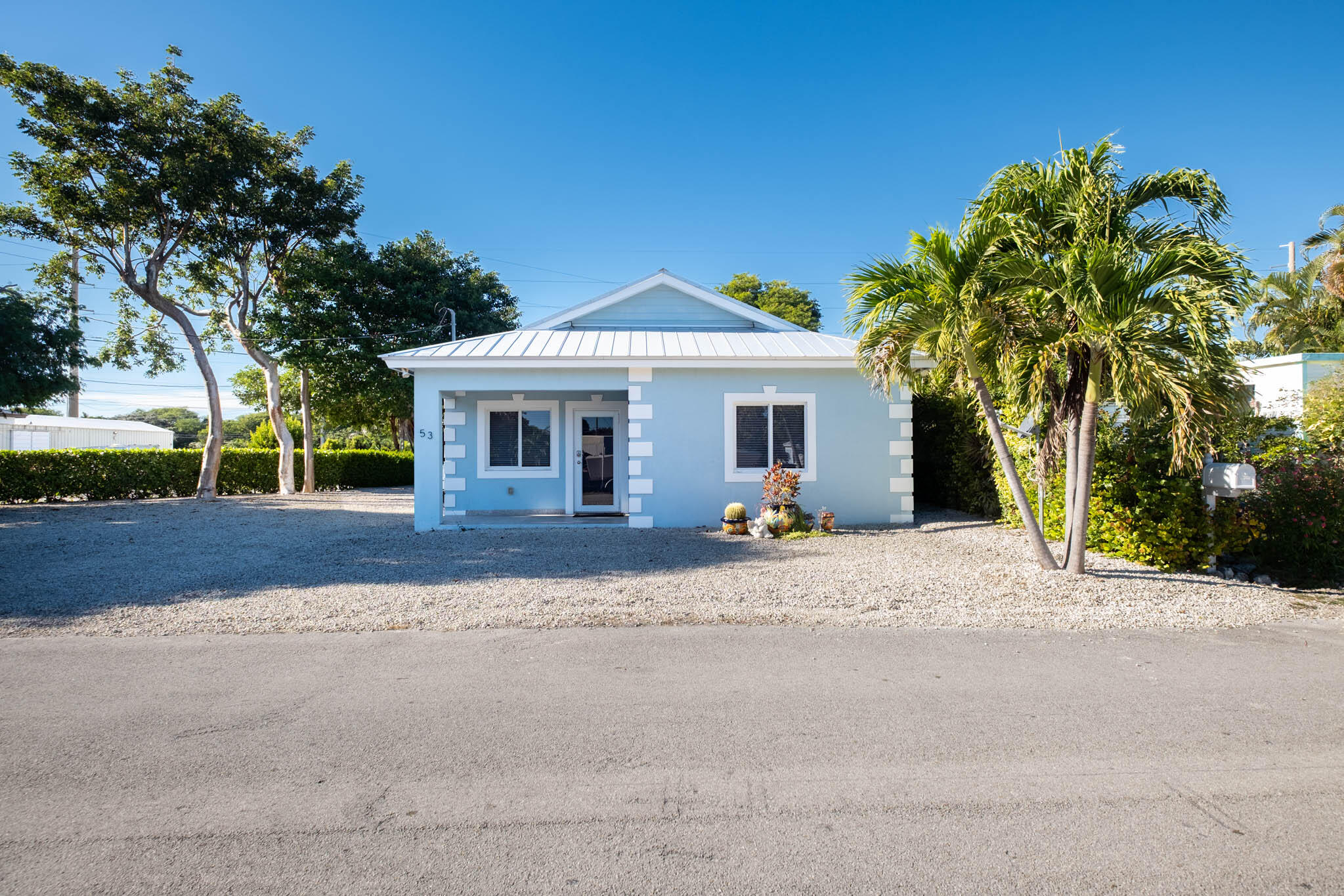 53 Jenny Lane Key Largo, FL 33037 - Photo 24 of 26 a view of a house with a outdoor space and palm trees