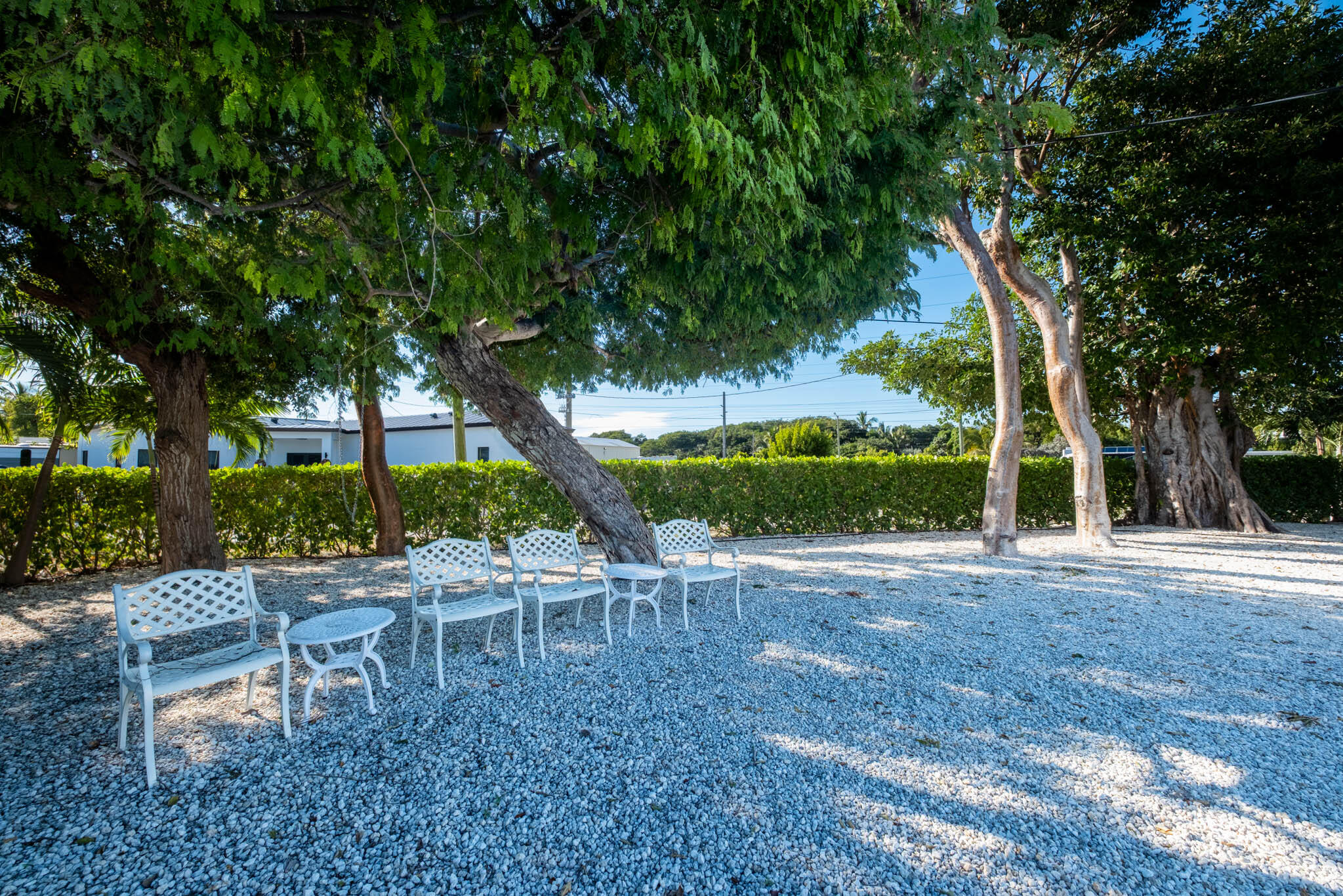 53 Jenny Lane Key Largo, FL 33037 - Photo 3 of 26 a view of a chair and table in backyard of a house