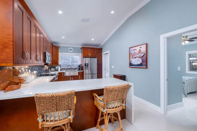 a kitchen with a table chairs and refrigerator