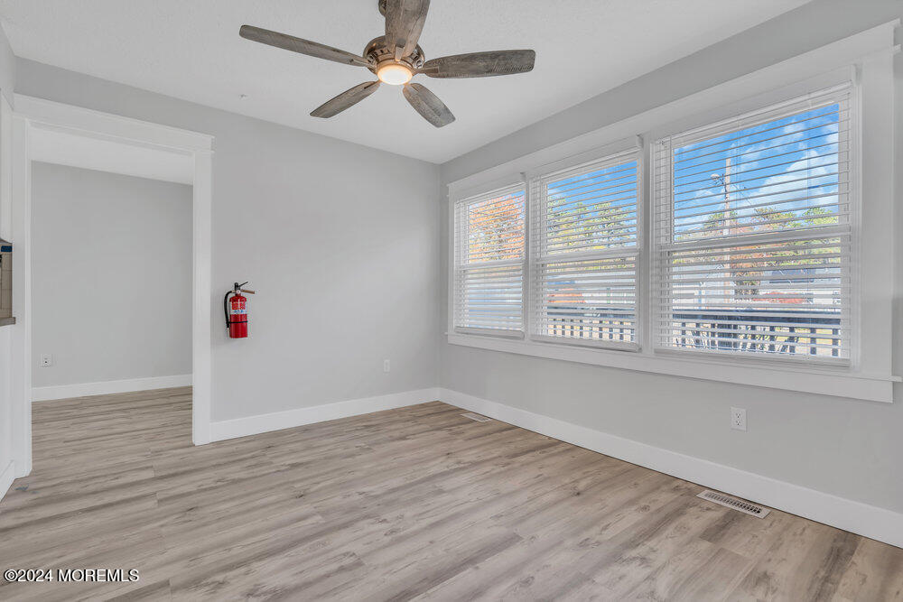 22 Spinnaker Way Waretown, NJ 08758 - Photo 13 of 29 a view of an empty room with wooden floor and a window