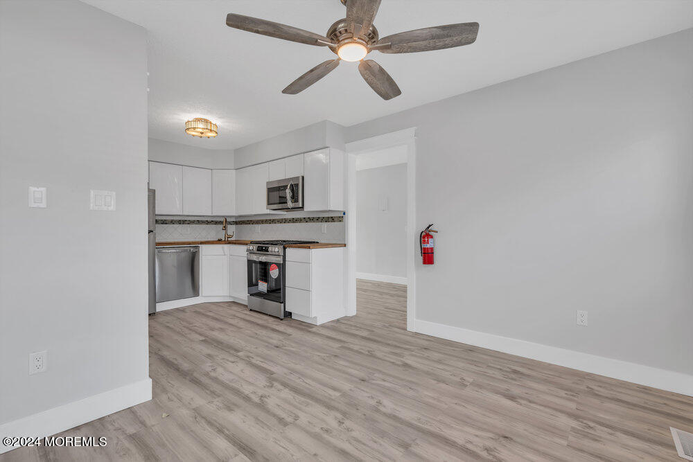 22 Spinnaker Way Waretown, NJ 08758 - Photo 14 of 29 a view of kitchen with wooden floor and ceiling fan