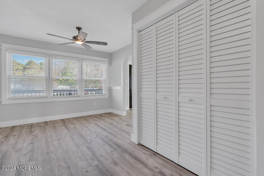 22 Spinnaker Way Waretown, NJ 08758 - Photo 16 of 29 a view of an empty room with wooden floor and a window