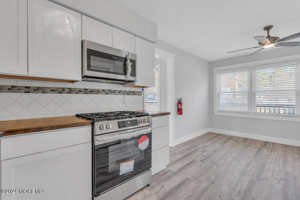22 Spinnaker Way Waretown, NJ 08758 - Photo 17 of 29 a kitchen with wooden floor and a stove top oven