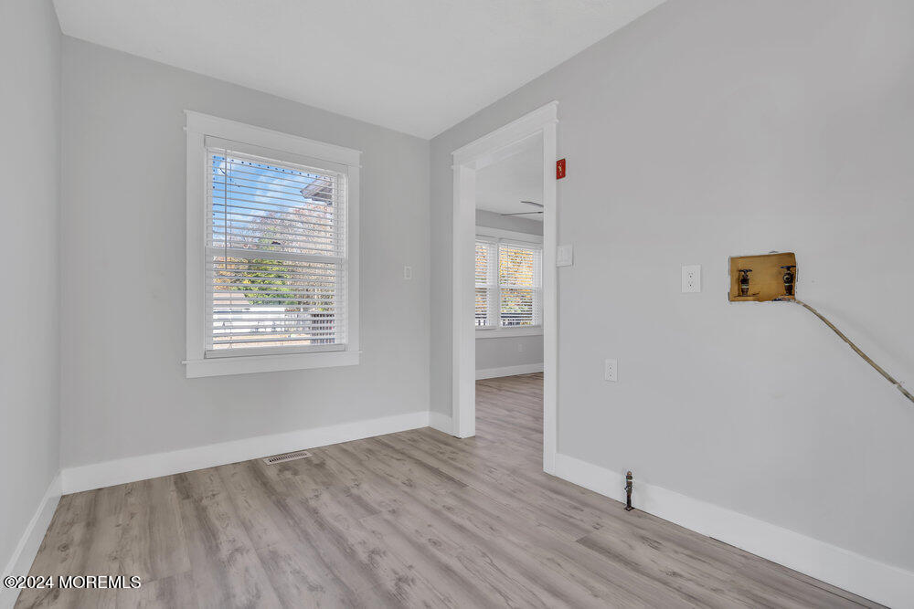 22 Spinnaker Way Waretown, NJ 08758 - Photo 18 of 29 an empty room with wooden floor and windows
