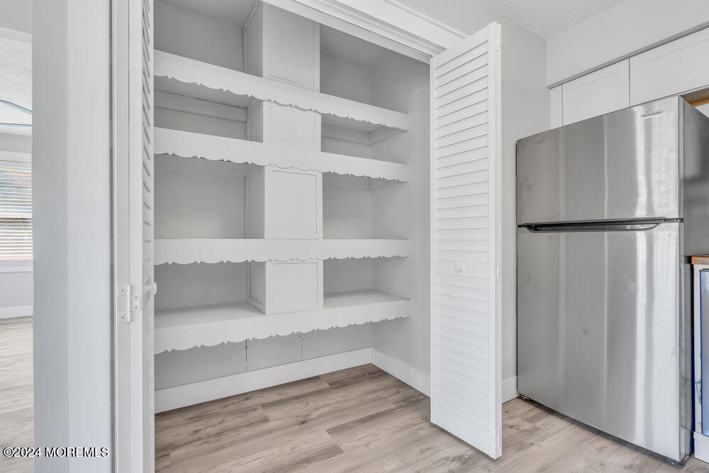 22 Spinnaker Way Waretown, NJ 08758 - Photo 20 of 29 a kitchen with cabinets and a refrigerator