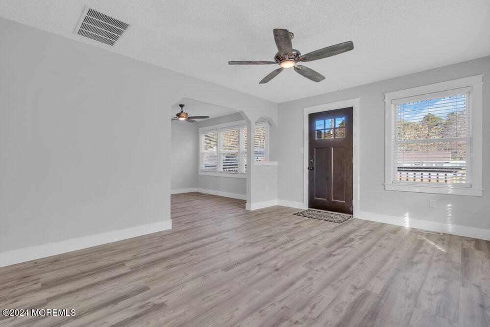 22 Spinnaker Way Waretown, NJ 08758 - Photo 2 of 29 a view of a livingroom with wooden floor ceiling fan and windows