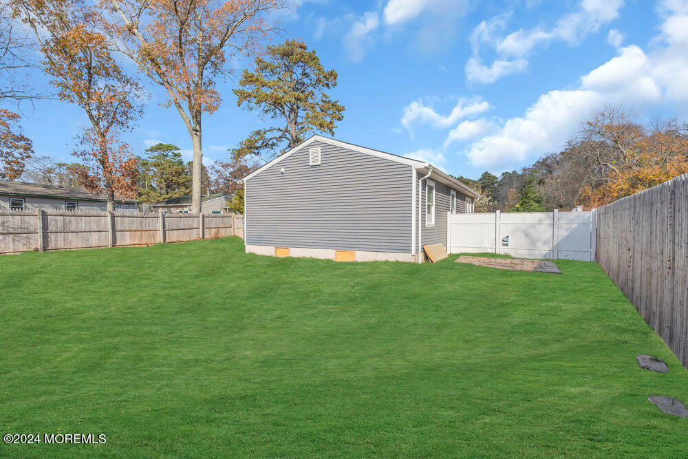 22 Spinnaker Way Waretown, NJ 08758 - Photo 29 of 29 a view of a backyard with a large tree