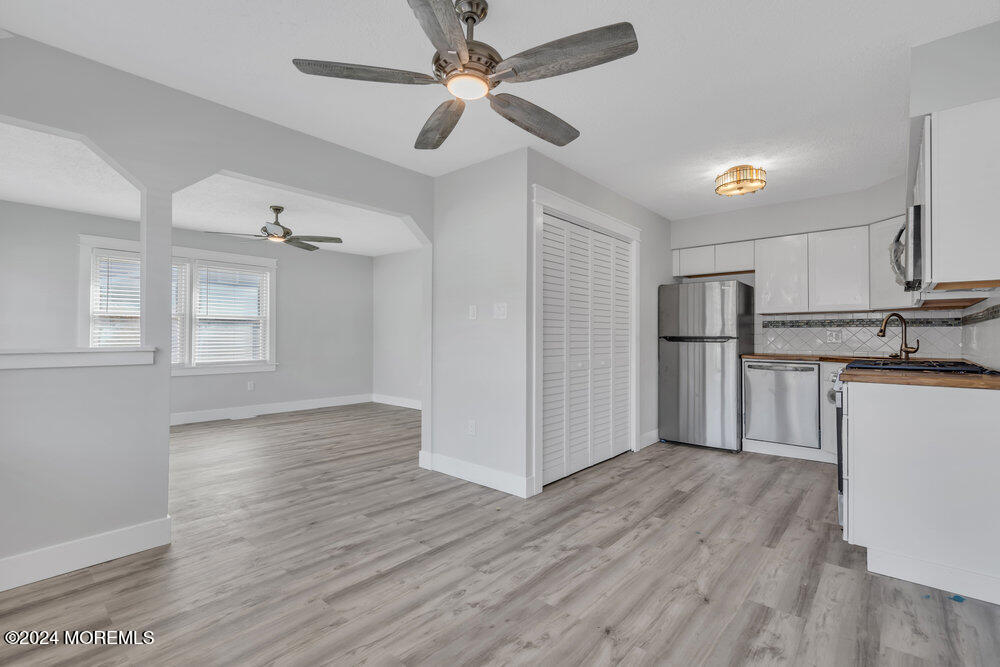 22 Spinnaker Way Waretown, NJ 08758 - Photo 3 of 29 a view of kitchen with stainless steel appliances refrigerator stove and wooden floor