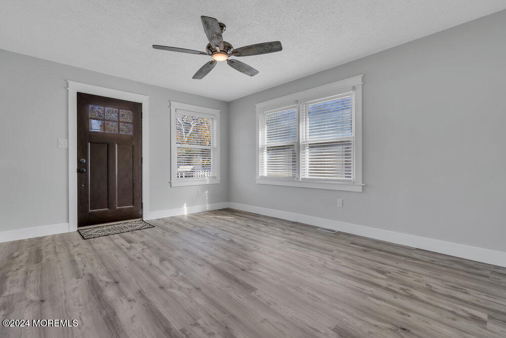22 Spinnaker Way Waretown, NJ 08758 - Photo 10 of 29 a view of an empty room with wooden floor and a window