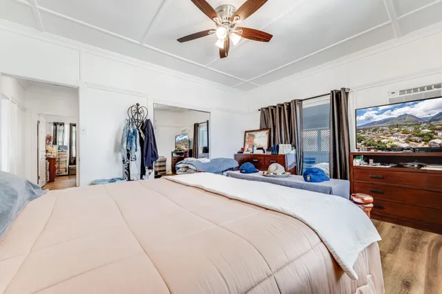 a bedroom with furniture and a large window