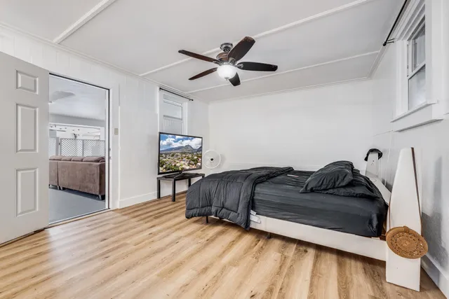 a bedroom with a large bed and a large window