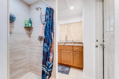 a view of a bedroom with a bed and glass door