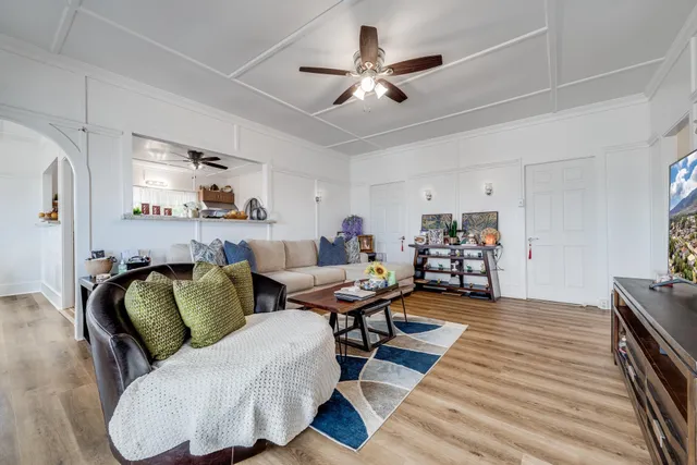 a living room with furniture and kitchen view