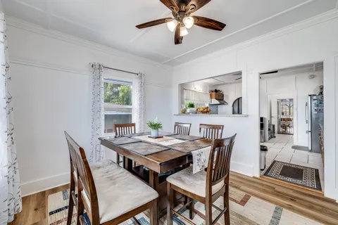 a dining room with furniture a rug and a large window