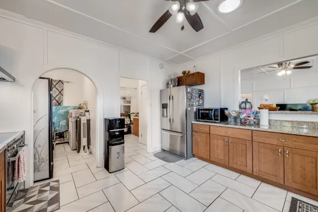 a kitchen with refrigerator and window