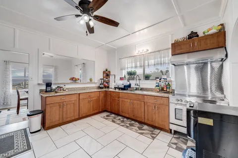 a kitchen with stainless steel appliances granite countertop a sink and cabinets