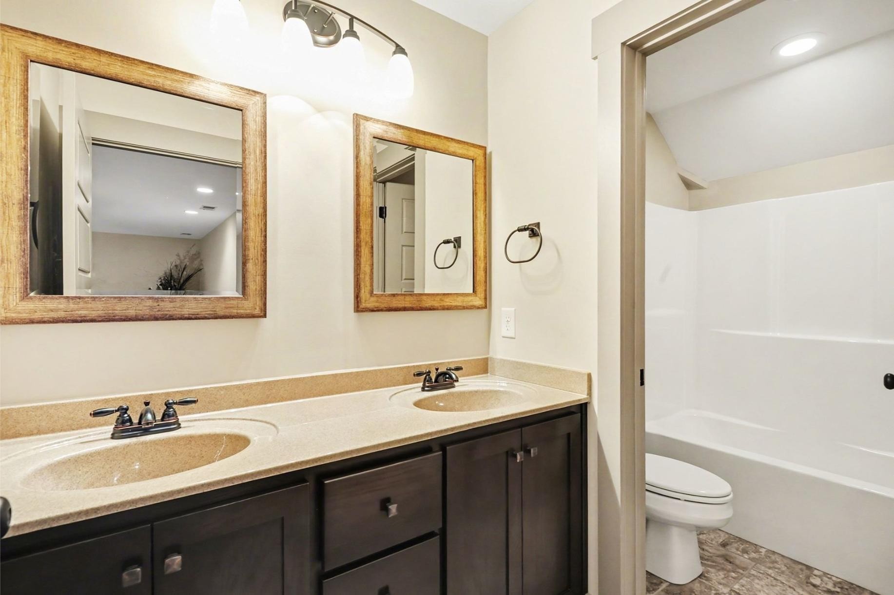 548 Strudwick Avenue Goodlettsville, TN 37072 - Photo 25 of 54 a bathroom with a double vanity sink toilet mirror and bathtub