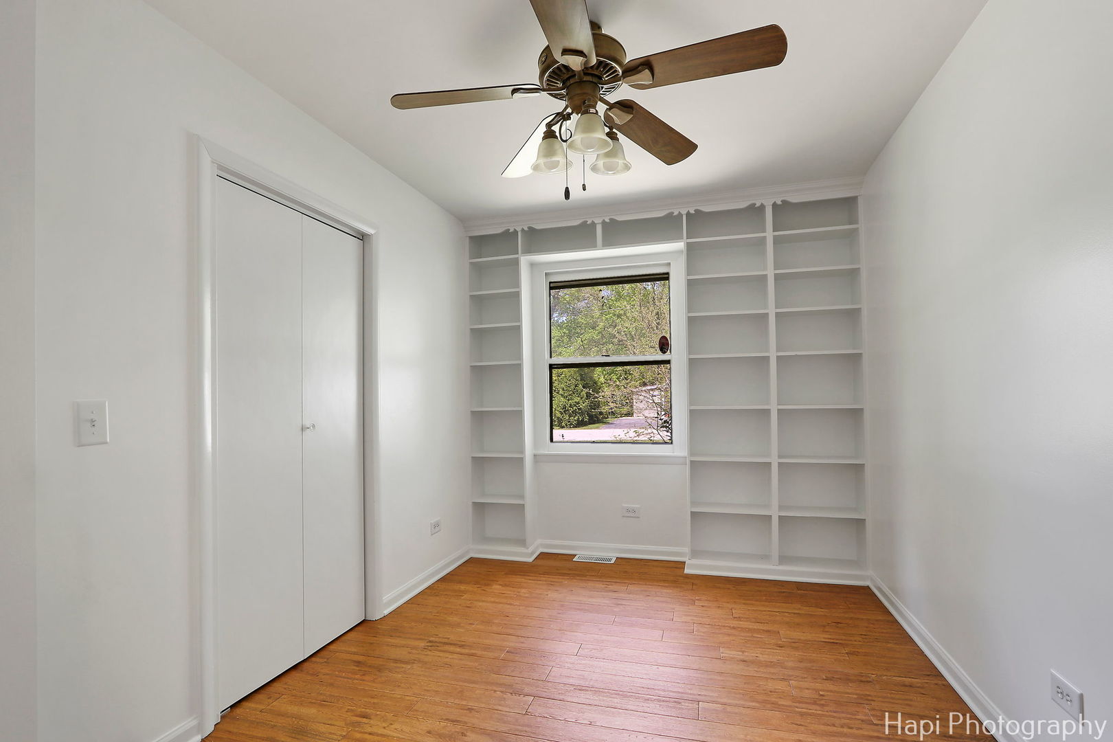 305 Pokagon Drive Algonquin, IL 60102 - Photo 16 of 28 an empty room with wooden floor chandelier fan and windows