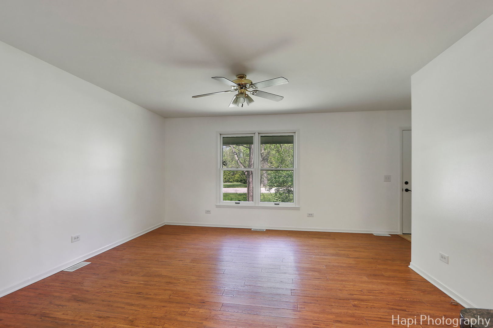 305 Pokagon Drive Algonquin, IL 60102 - Photo 4 of 28 an empty room with wooden floor and windows