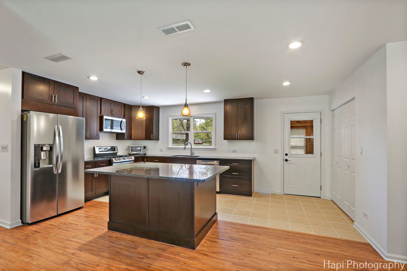 305 Pokagon Drive Algonquin, IL 60102 - Photo 7 of 28 a kitchen with stainless steel appliances granite countertop a refrigerator a sink dishwasher a stove and a refrigerator with wooden floor
