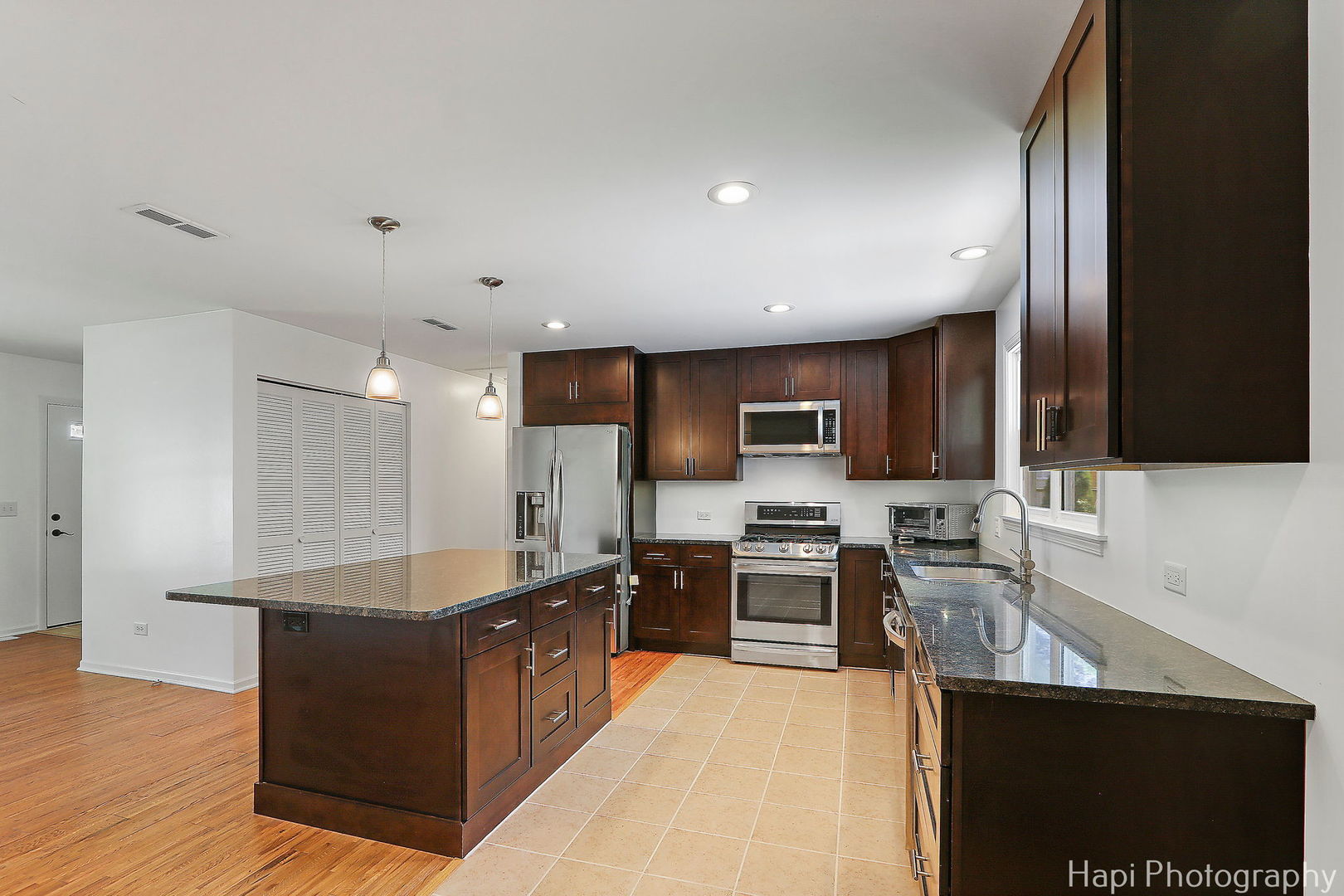 305 Pokagon Drive Algonquin, IL 60102 - Photo 8 of 28 a large kitchen with stainless steel appliances a sink a stove and cabinets