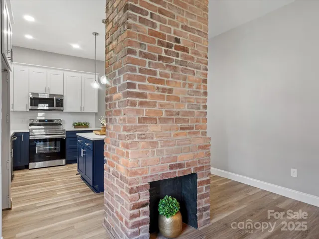 a kitchen with granite countertop a stove top oven a sink and a microwave