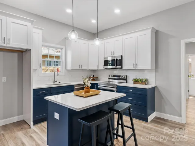 a kitchen with a sink a stove a refrigerator and cabinets