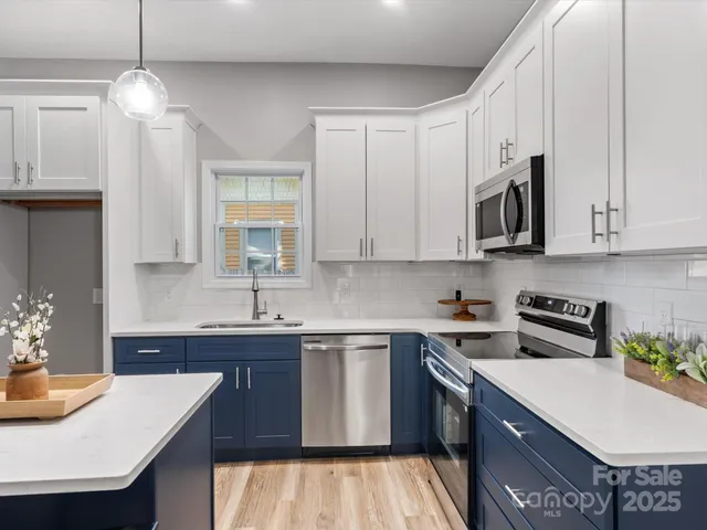 a kitchen with stainless steel appliances granite countertop a sink stove and cabinets