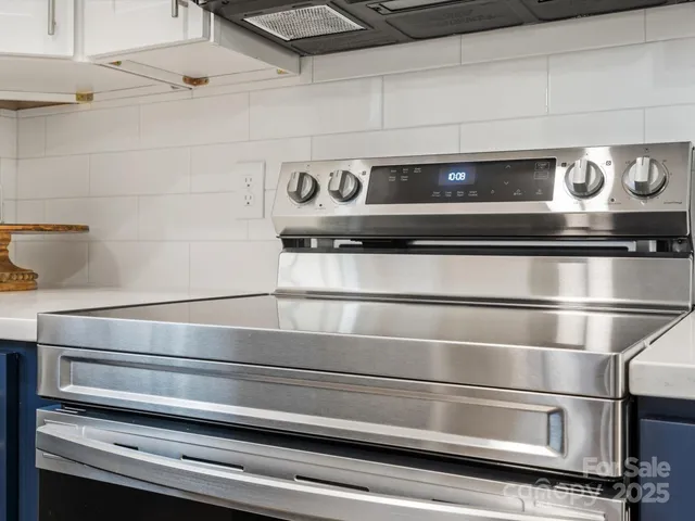 a stove top oven sitting inside of a kitchen