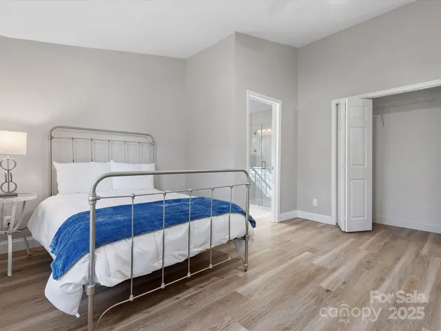 a bedroom with a bed and a night stand