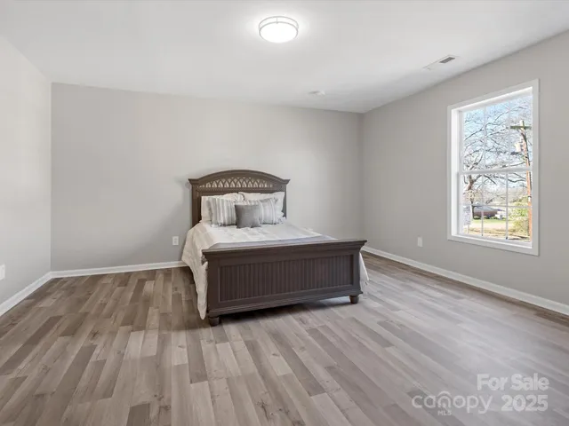 a room with a bed and window