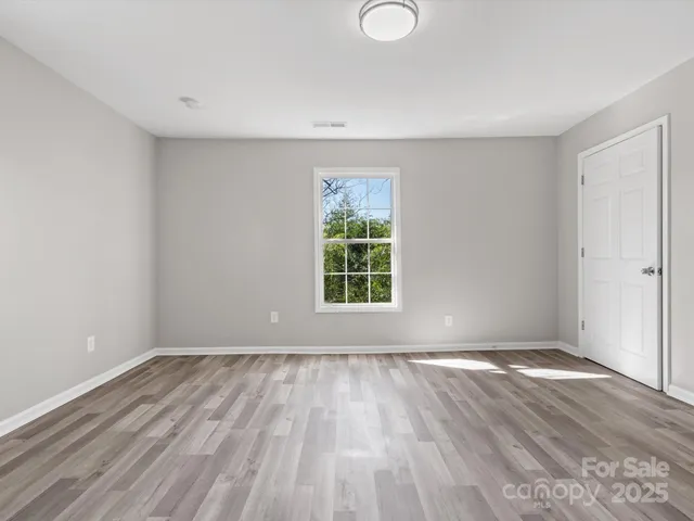 a view of room with window and hardwood floor