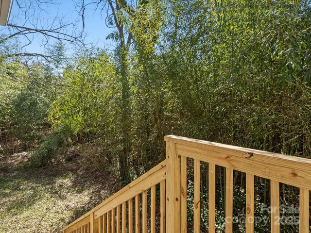 a view of a wooden fence and trees