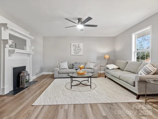 a living room with furniture and a fireplace
