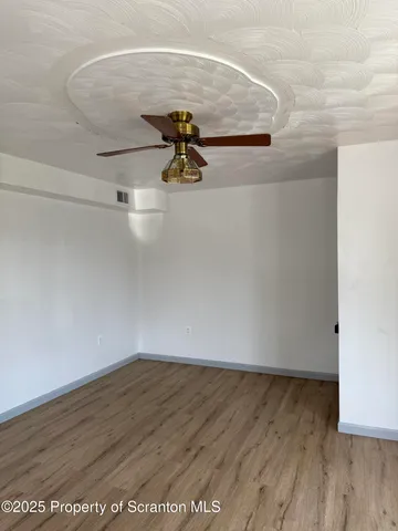 a view of a room with wooden floor