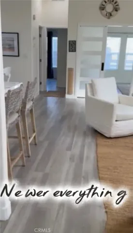 view of hall way with wooden floor and staircase