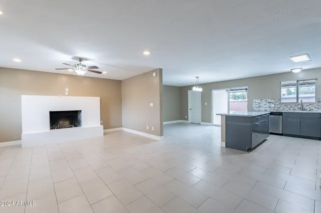 a view of a kitchen with a sink and chandelier fan