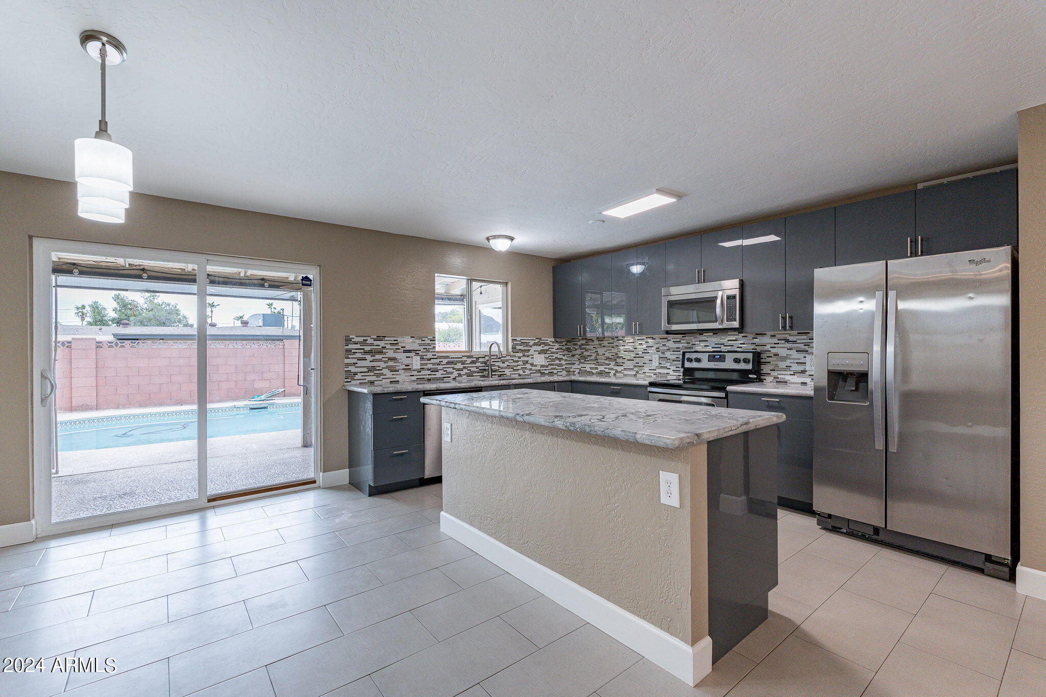 1320 East Orchid Lane Phoenix, AZ 85020 - Photo 14 of 48 a kitchen with stainless steel appliances granite countertop a refrigerator and a sink