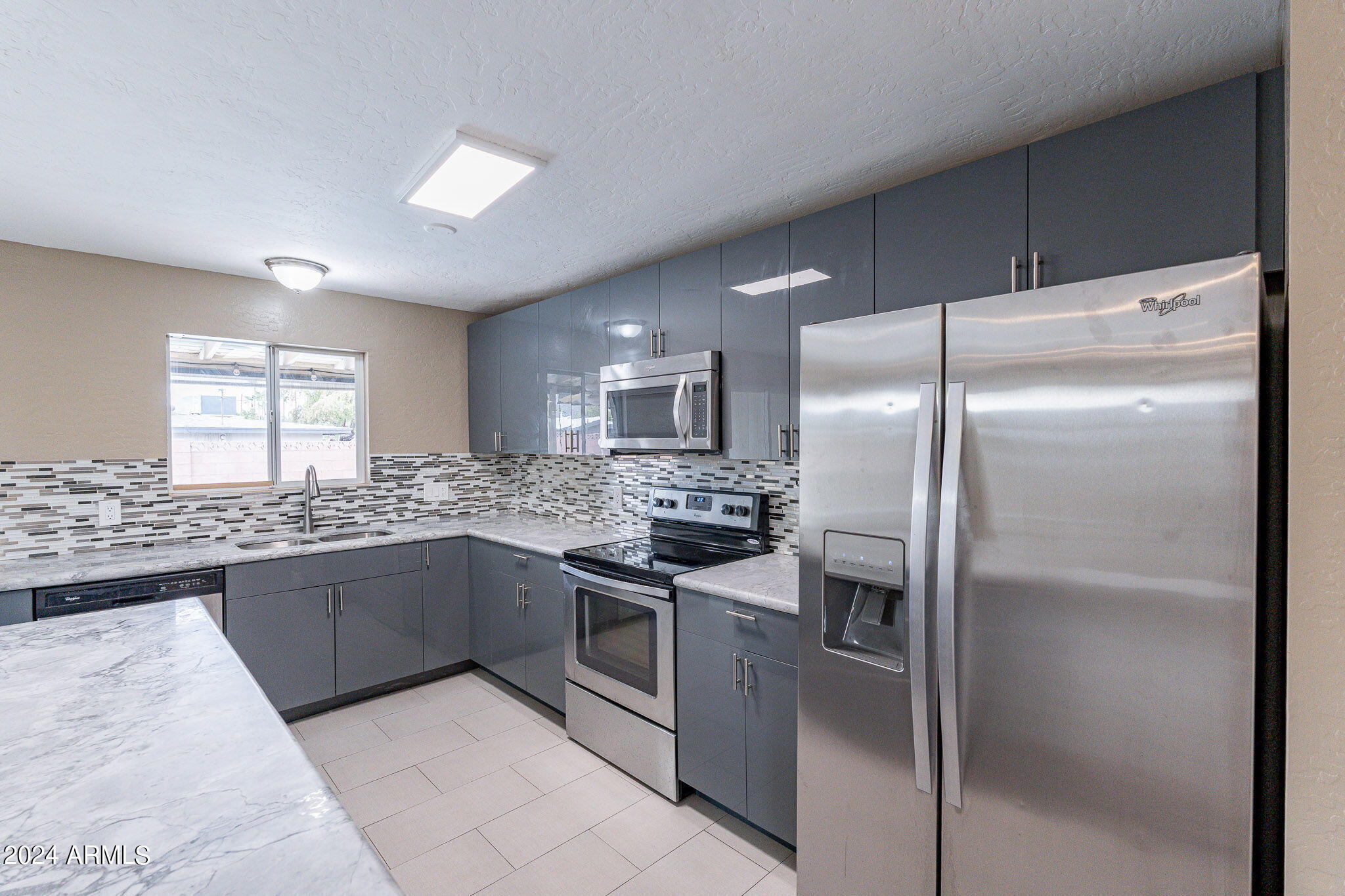 1320 East Orchid Lane Phoenix, AZ 85020 - Photo 15 of 48 a kitchen with stainless steel appliances granite countertop a refrigerator and a stove