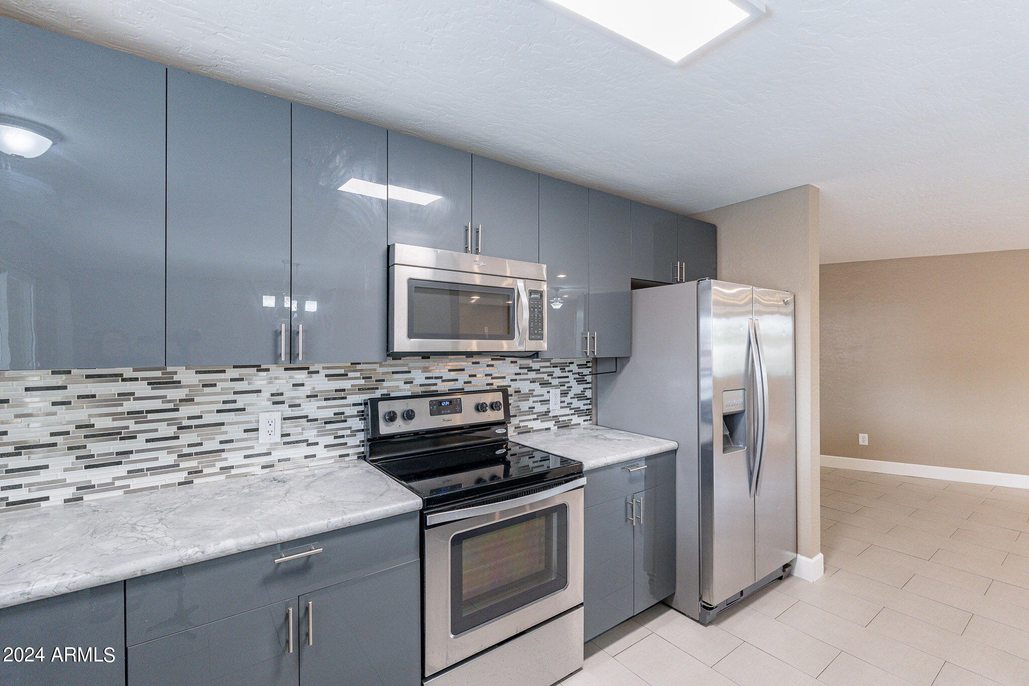 1320 East Orchid Lane Phoenix, AZ 85020 - Photo 18 of 48 a kitchen with stainless steel appliances a stove microwave and refrigerator